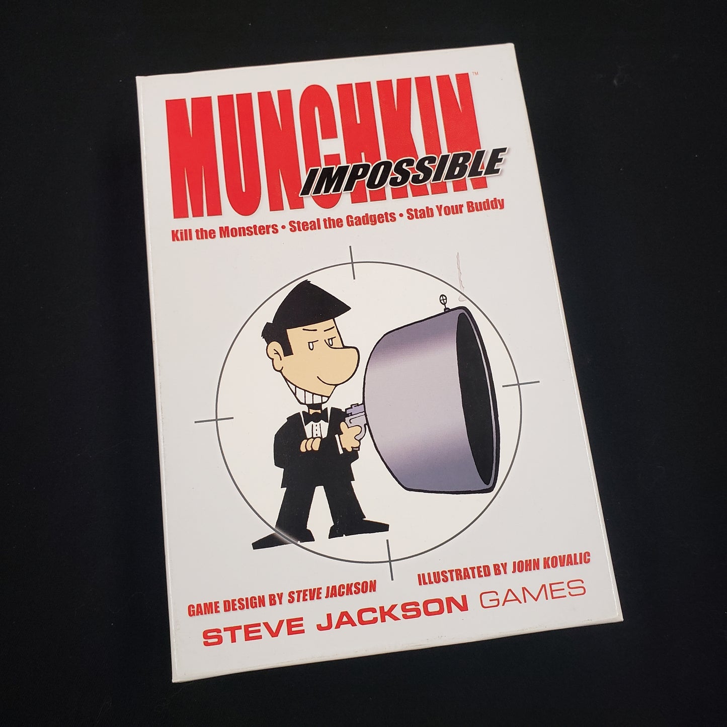 Image shows the front cover of the box of the Munchkin Impossible card game