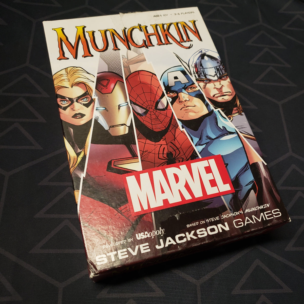 Image shows the front cover of the box of the Munchkin Marvel card game