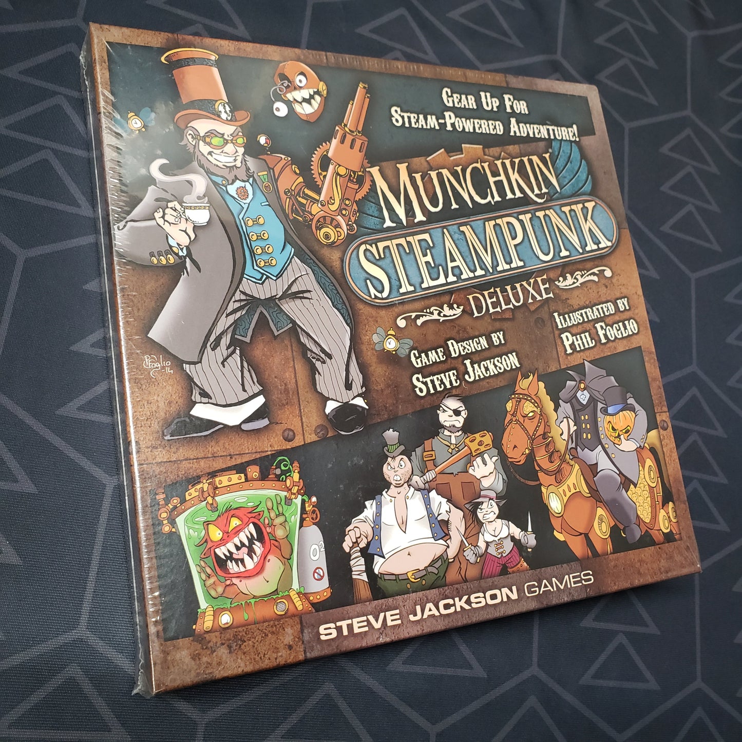 Image shows the front cover of the box of the Munchkin Steampunk Deluxe card game