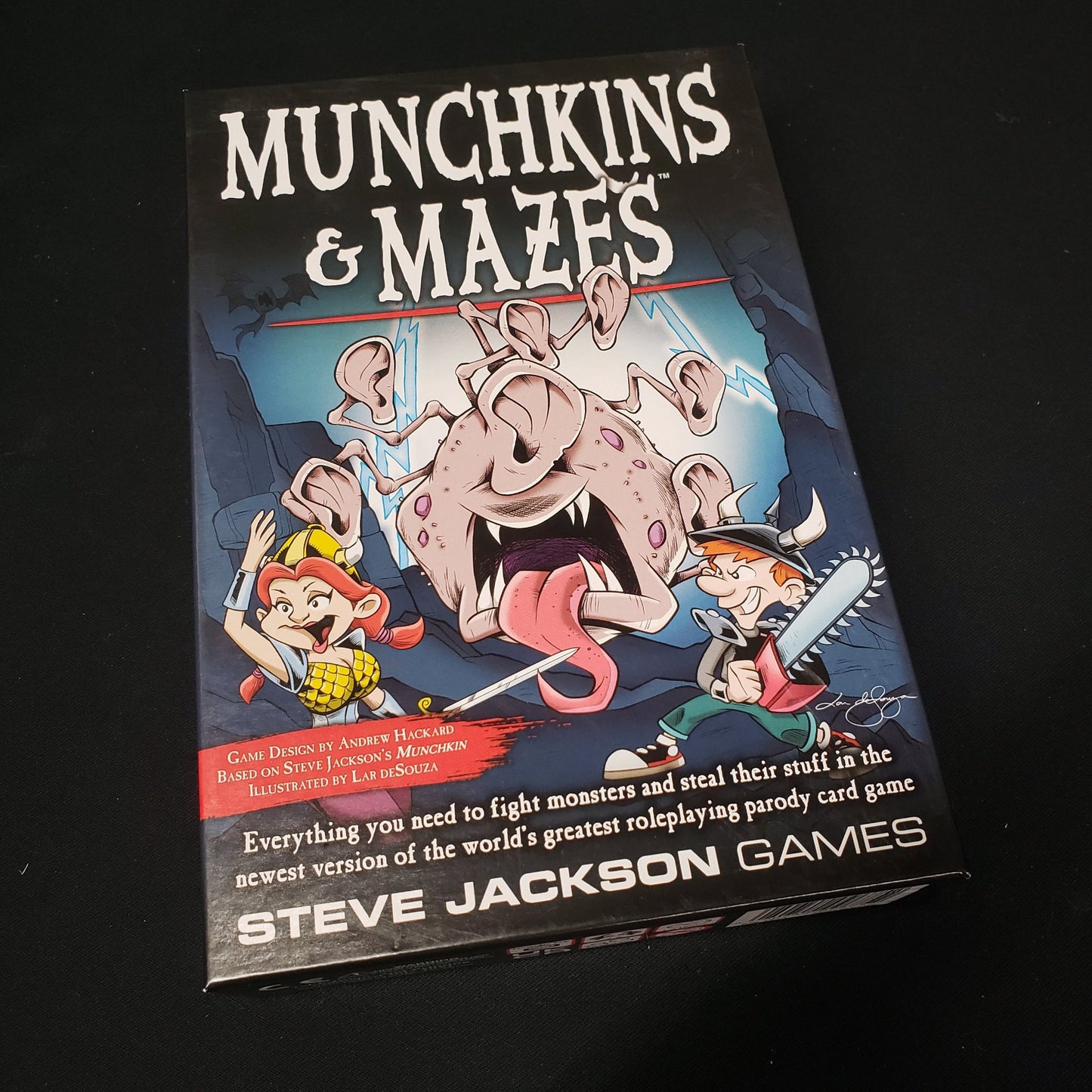 Image shows the front cover of the box of the Munchkins & Mazes card game