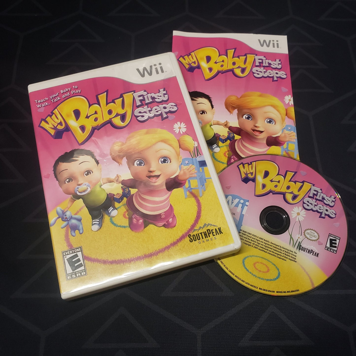 Image shows the case, manual and disc for the video game My Baby: First Steps for Nintendo Wii