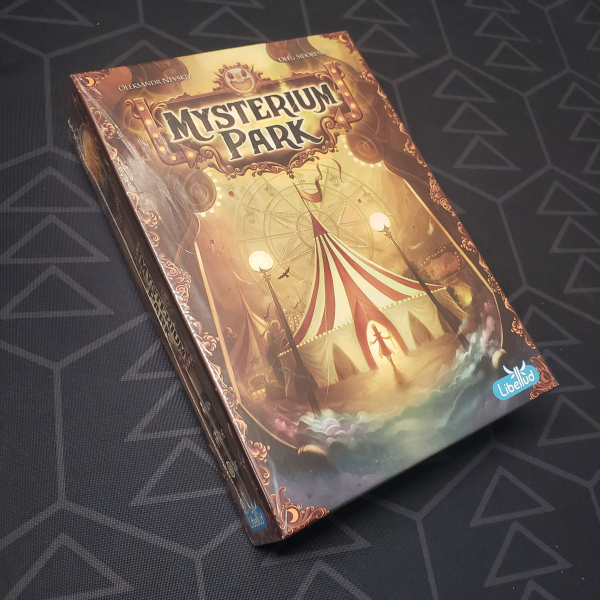 Image shows the front cover of the box for the Mysterium Park board game
