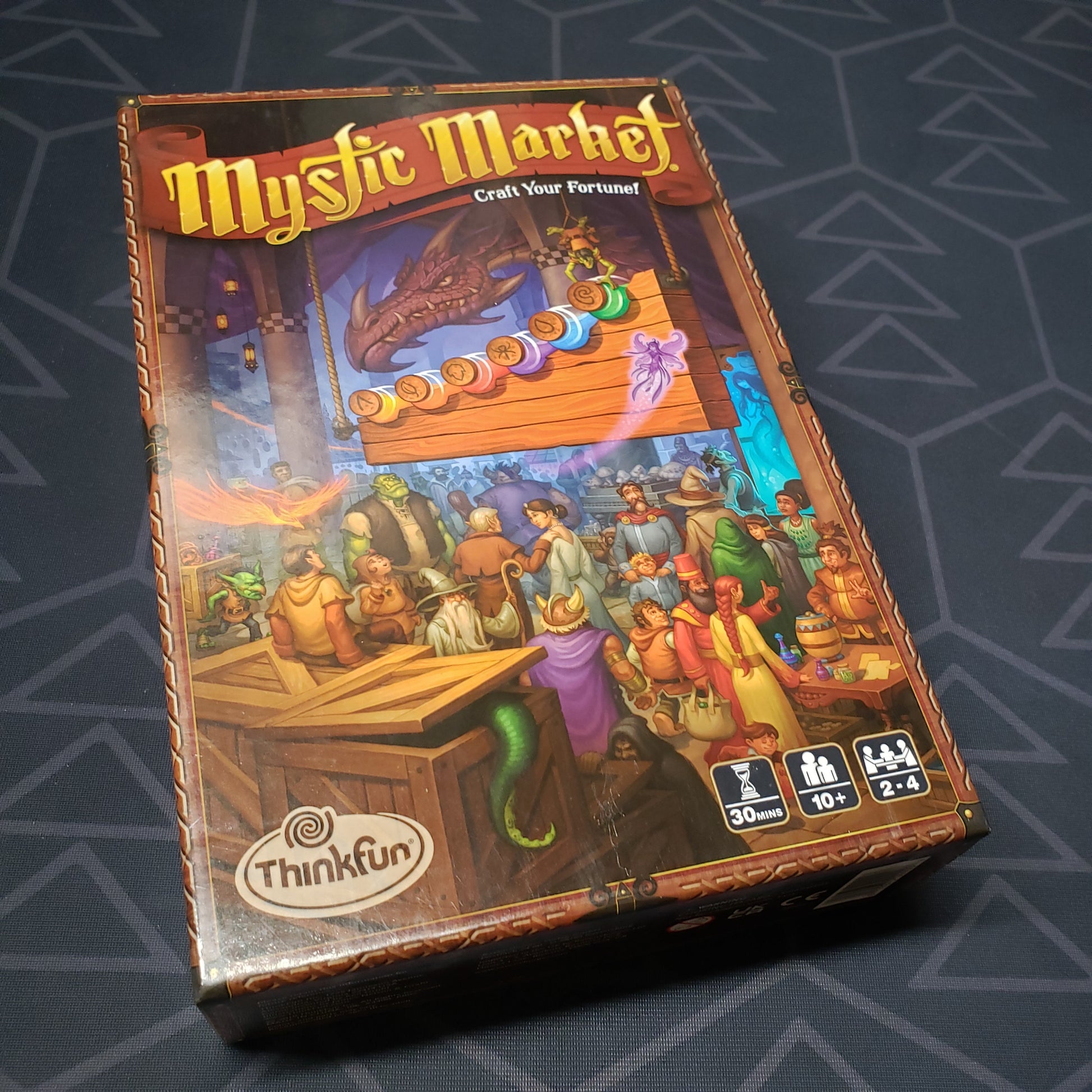 Image shows the front cover of the box for the Mystic Market card game