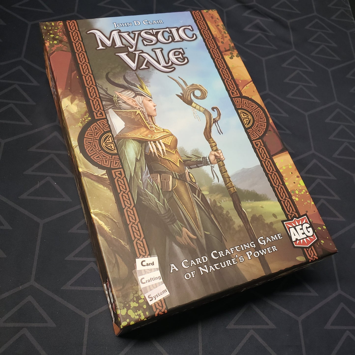 Image shows the front cover of the box of the Mystic Vale board game