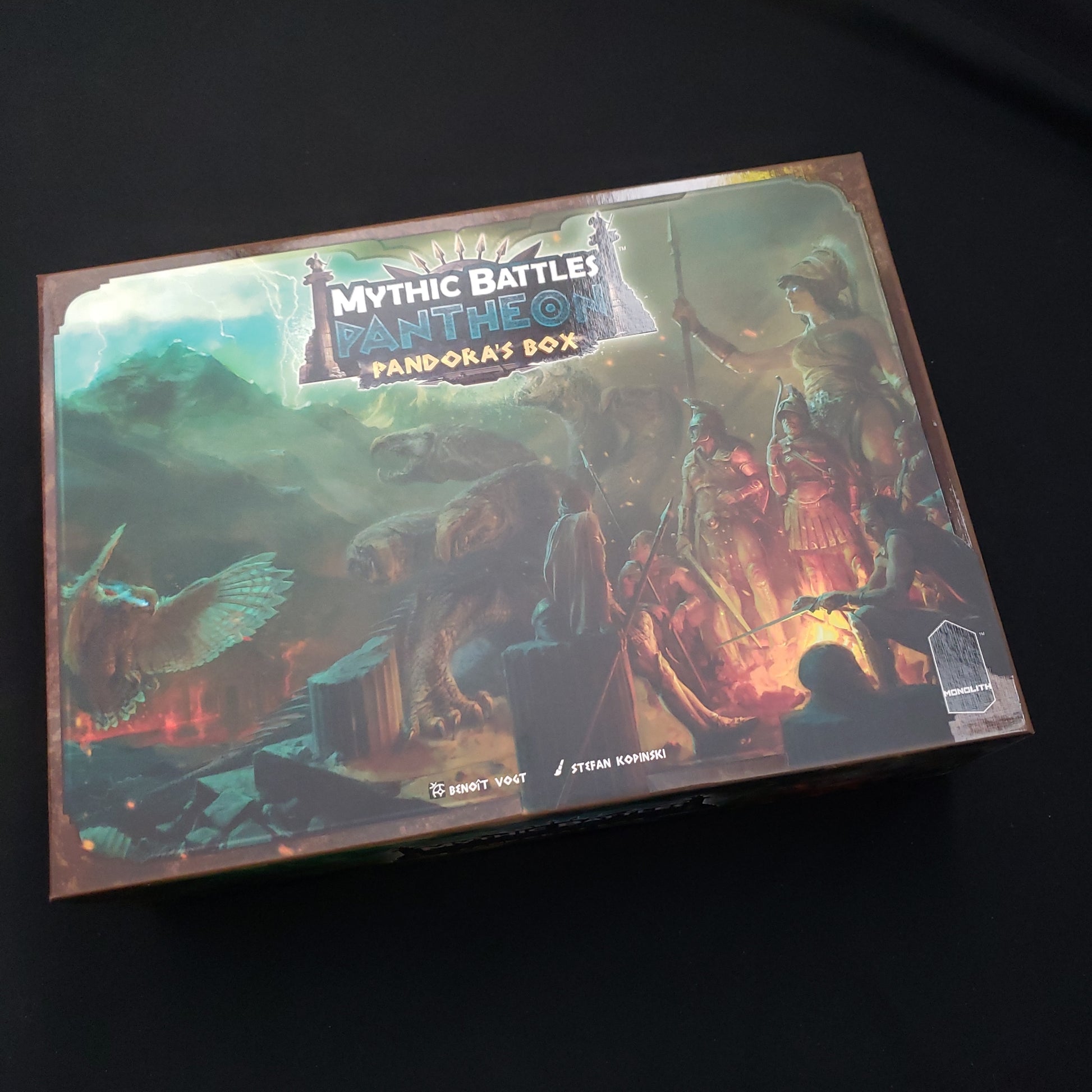 Image shows the front cover of the box of the Pandora's ox expansion for the Mythic Battles Pantheon board game