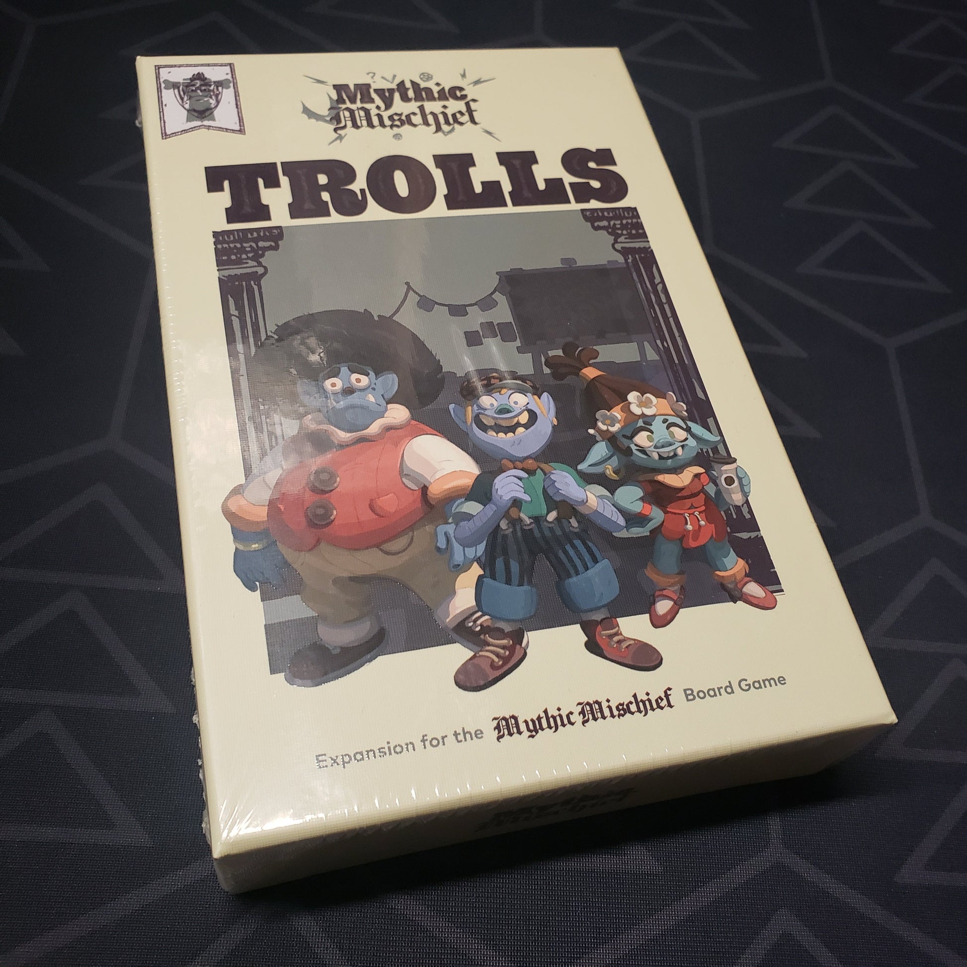 Image shows the front cover of the box of the Trolls expansion for the board game Mythic Mischief