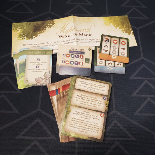 Image shows the fanned-out cards & instructions for the Winds of Magic mini expansion for the board game Mythwind
