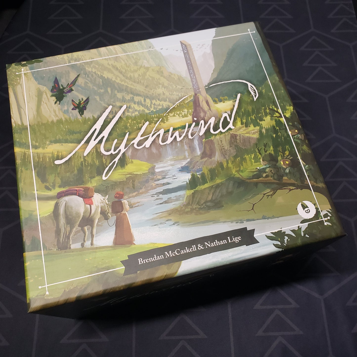 Image shows the front cover of the box for the Mythwind board game