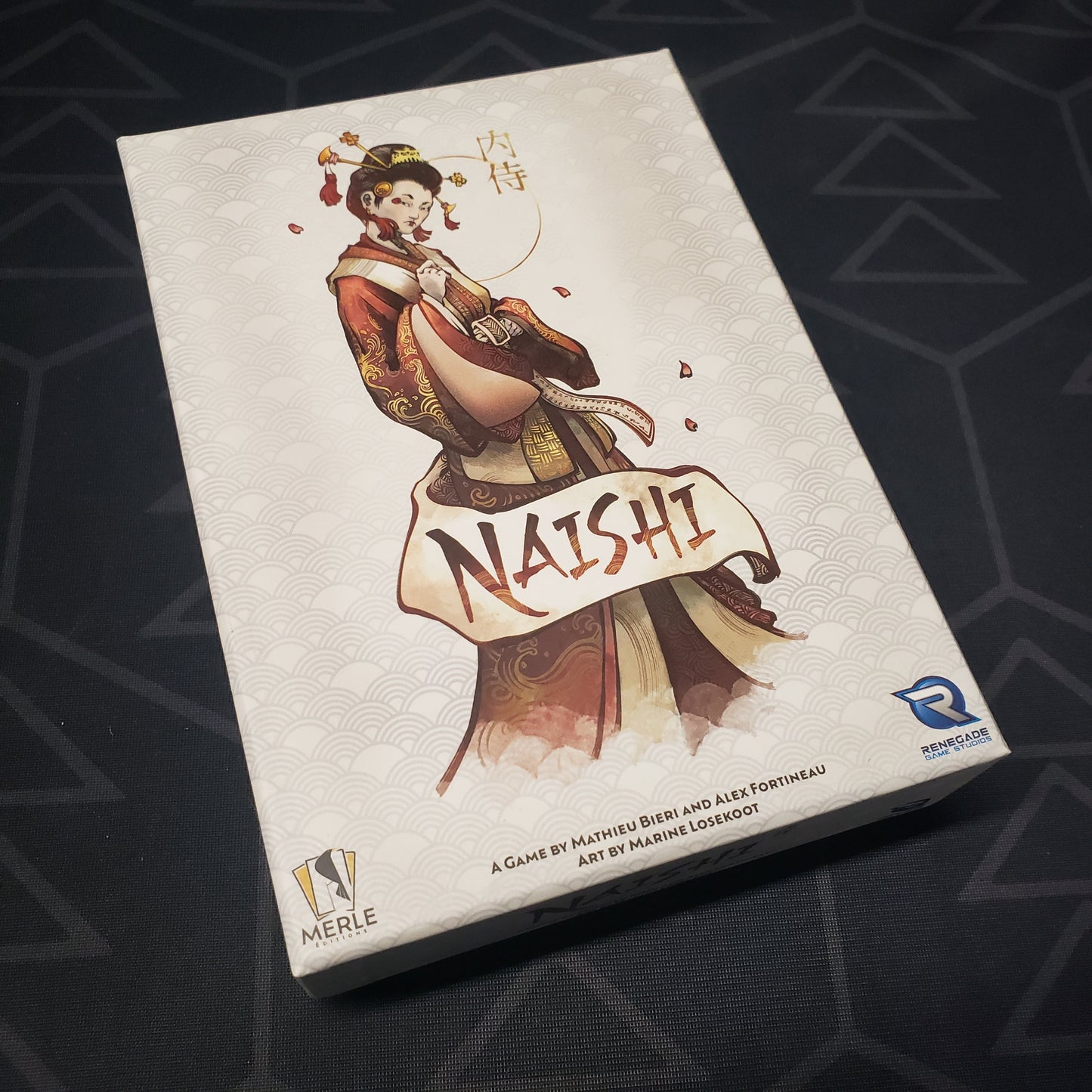 Image shows the front cover of the box for the Naishi card game