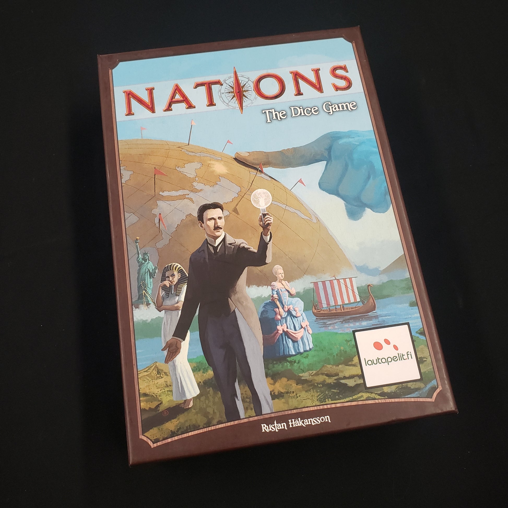 Image shows the front cover of the box of Nations: The Dice Game