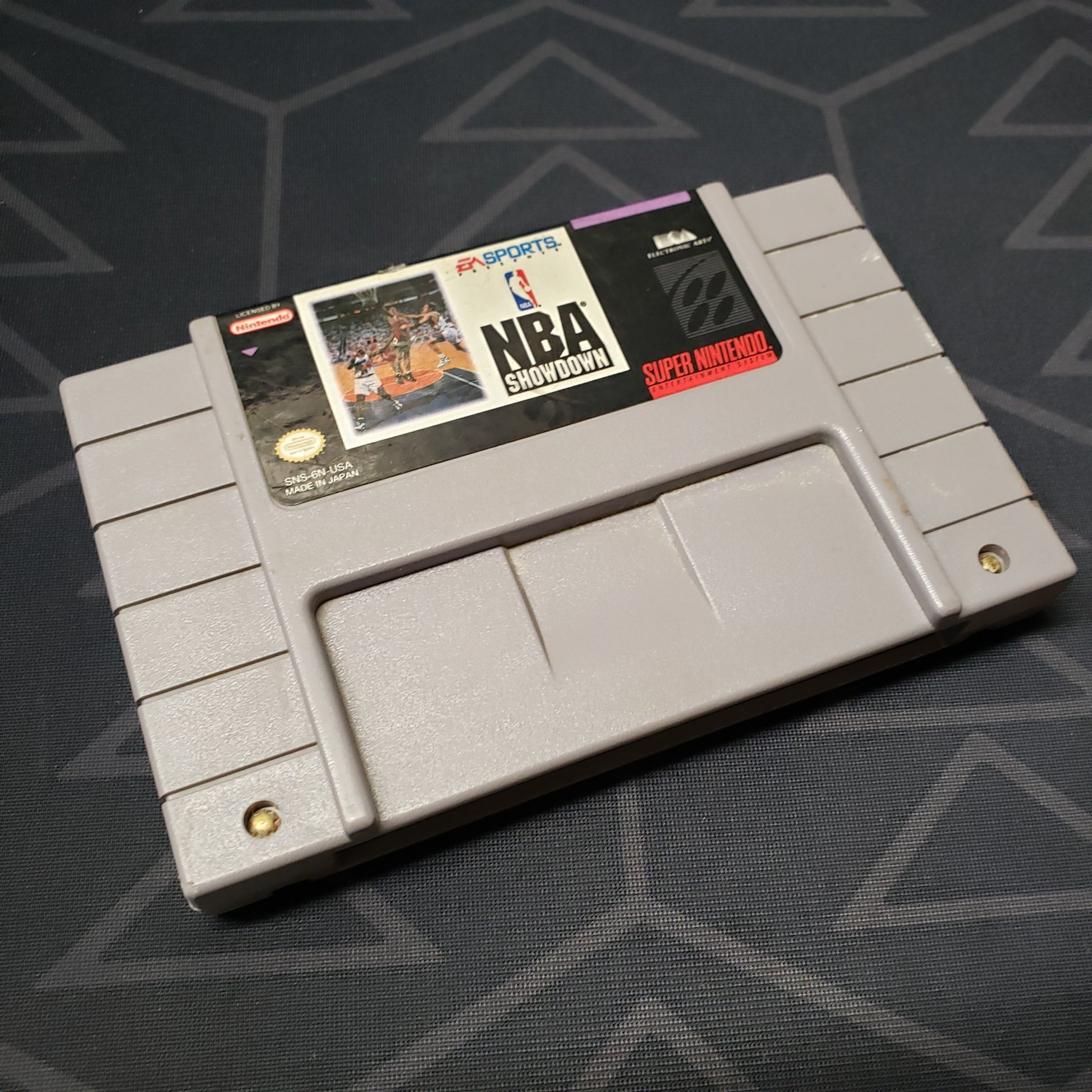 Image shows the front of the cartridge for the video game NBA Showdown for the Super Nintendo