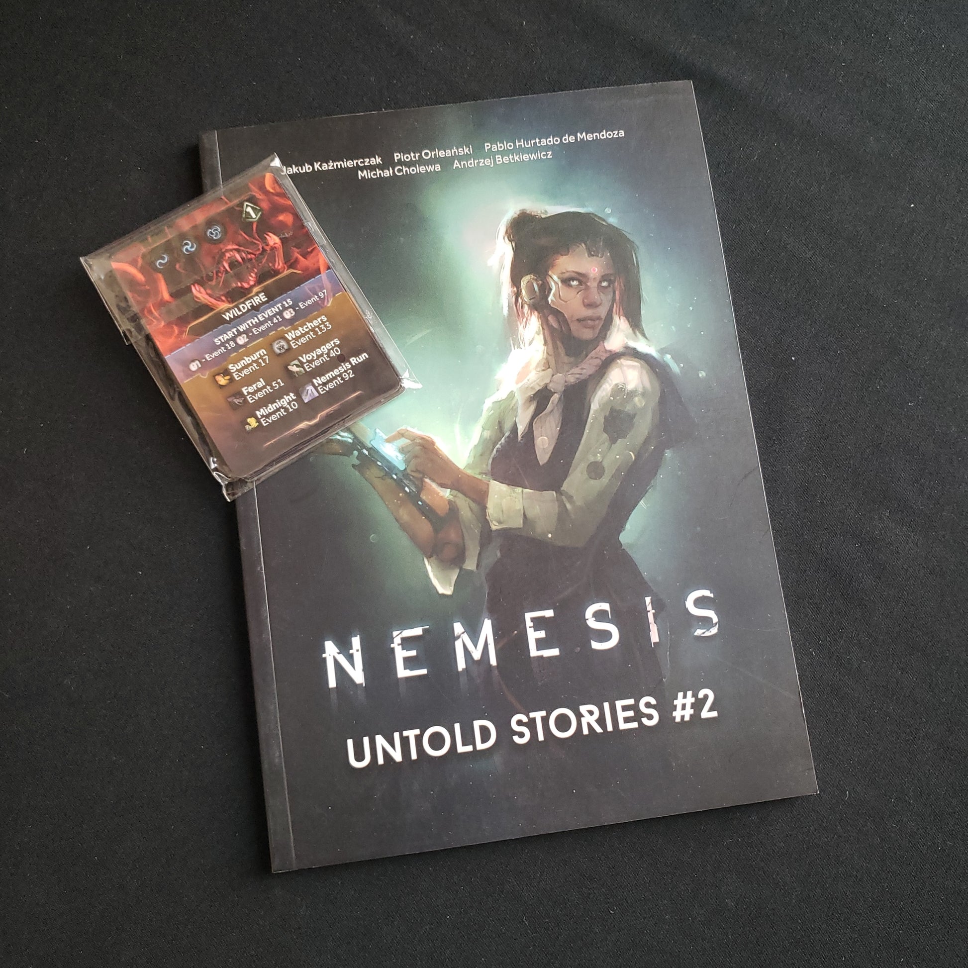 Image shows the front cover of the book and card pack for the Untold Stories #2 expansion for the board game Nemesis