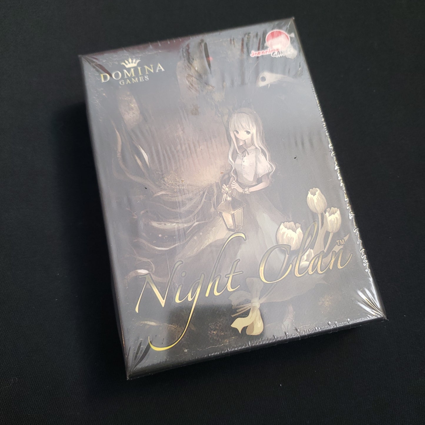 Image shows the front cover of the box of the Night Clan board game