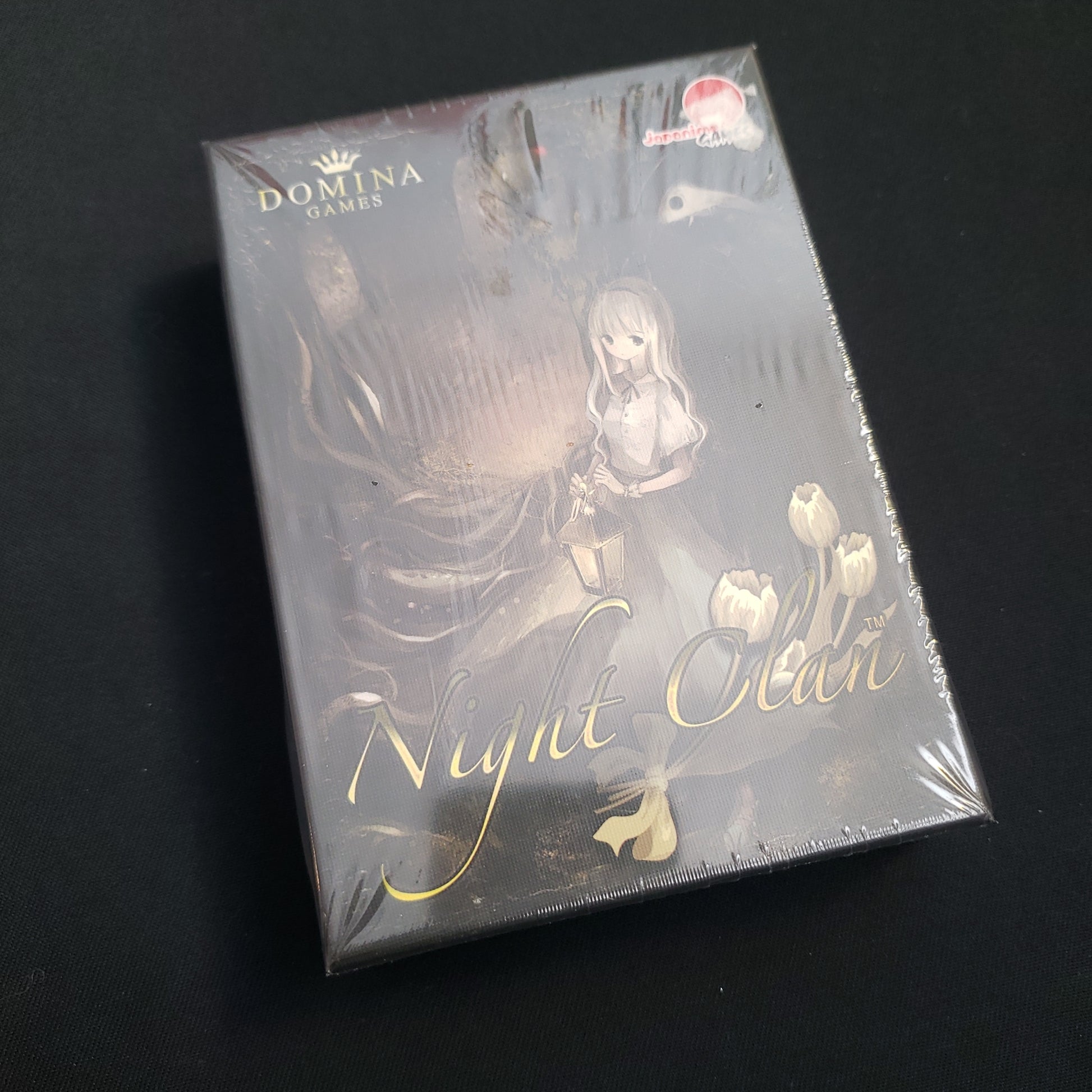 Image shows the front cover of the box of the Night Clan board game