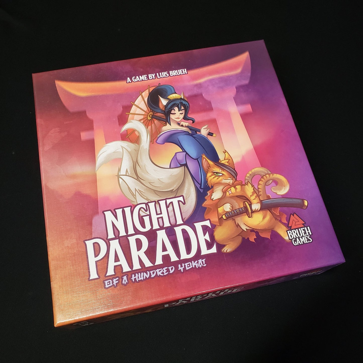 Image shows the front cover of the box of the board game Night Parade of a Hundred Yokai