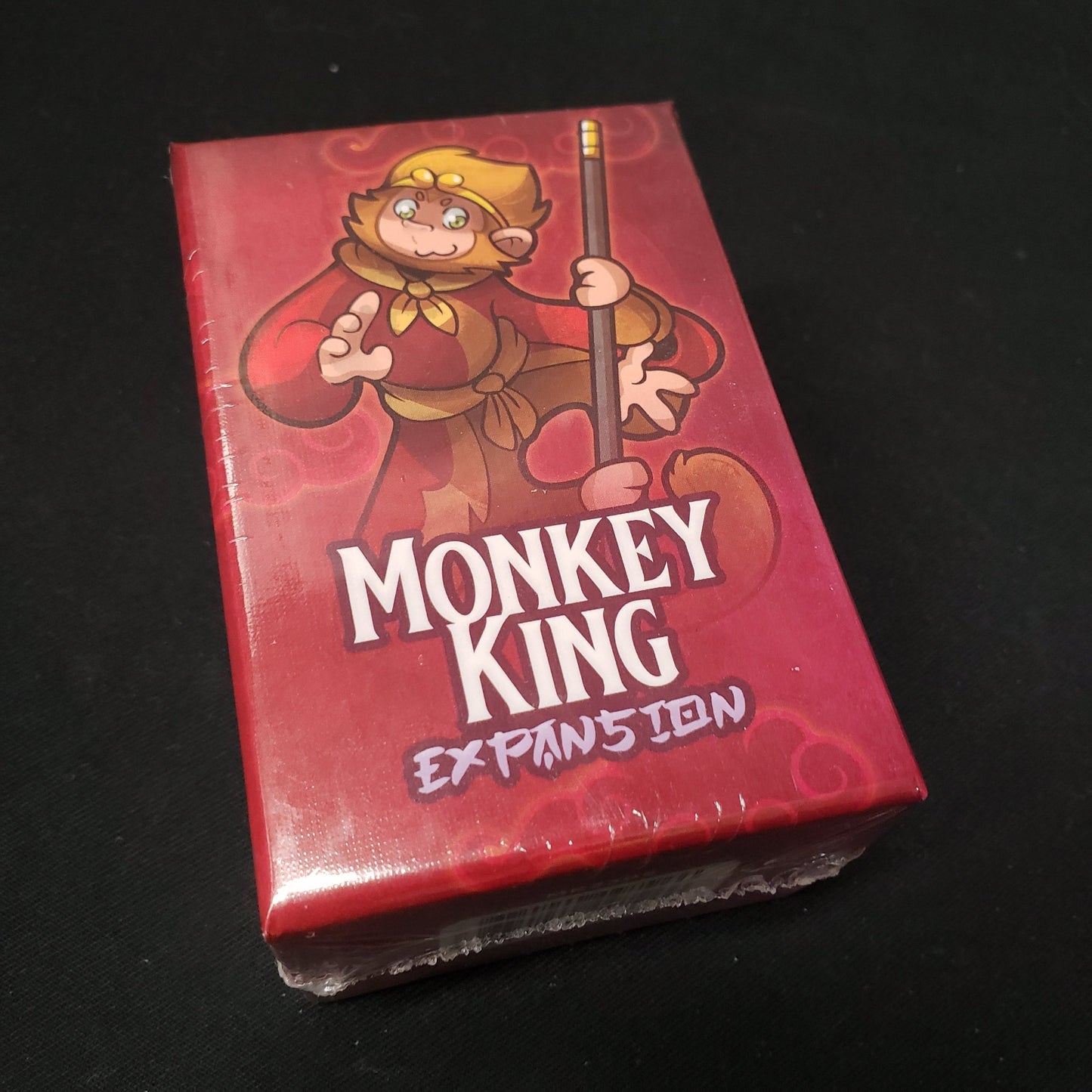 Image shows the front cover of the box of the Monkey King expansion for the board game Night Parade of a Hunderd Yokai