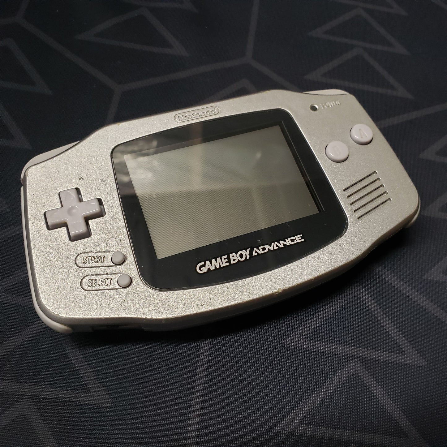 Image shows the front of a Game Boy Advance handheld console