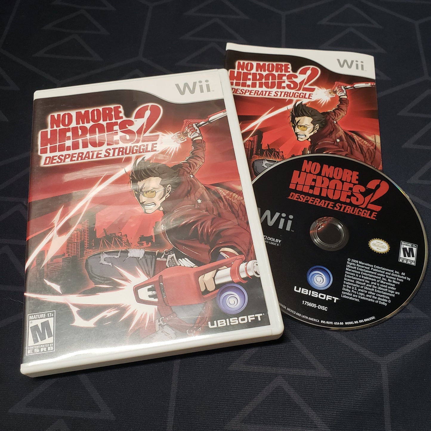 Image shows the case, manual and disc for the video game No More Heroes 2: Desperate Struggle for Nintendo Wii