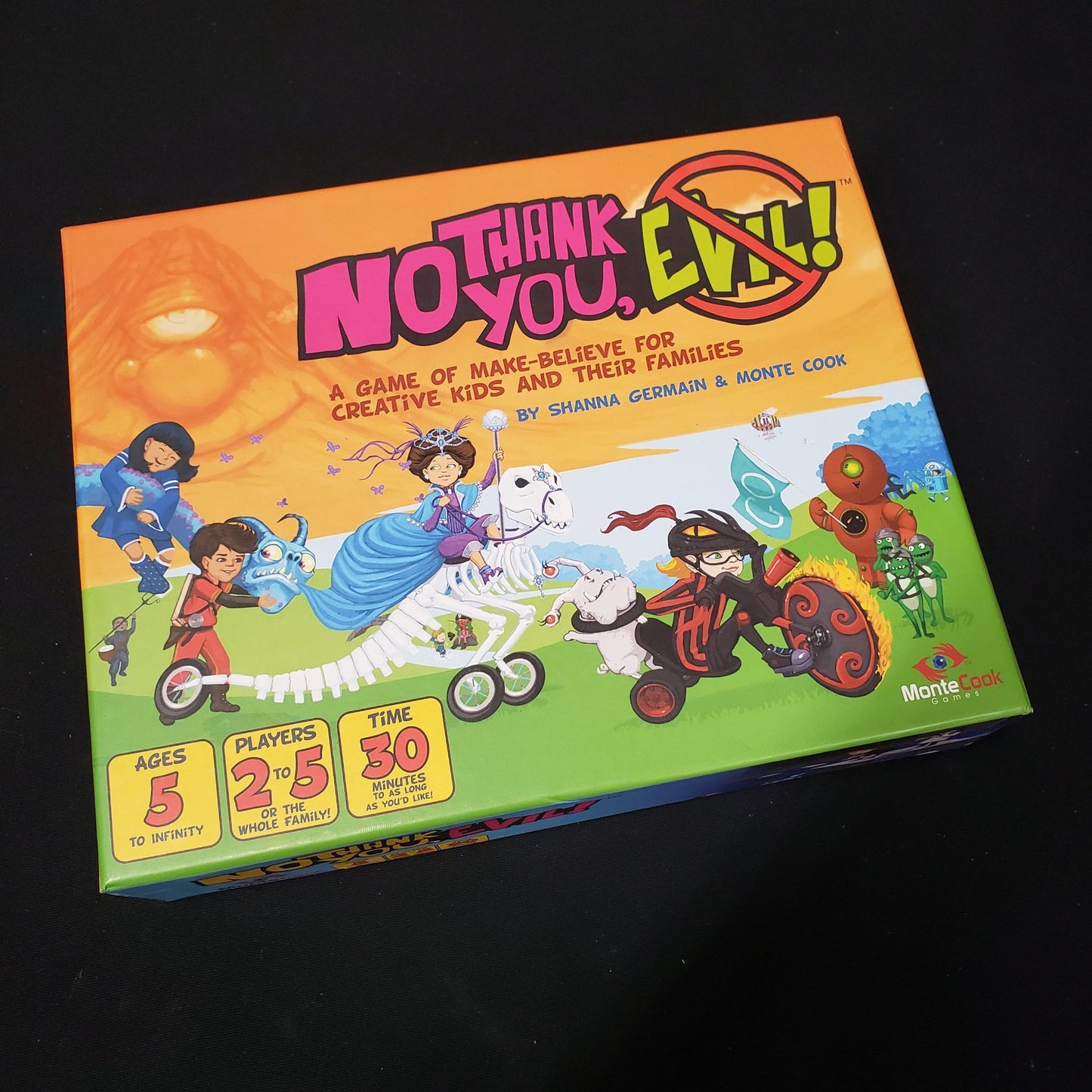 Image shows the front cover of the box of the No Thank You, Evil! family roleplaying game