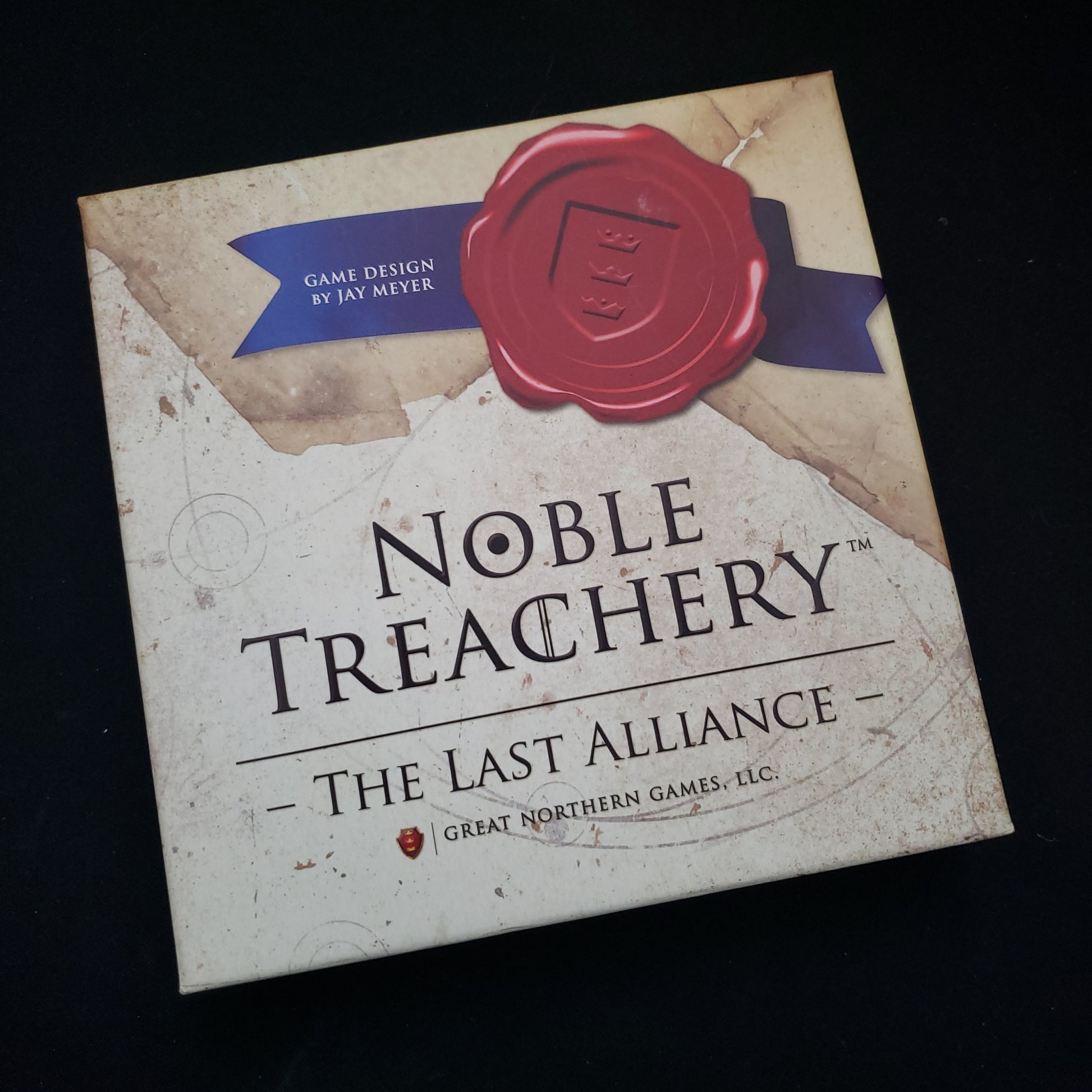 Image shows the front cover of the box of the Noble Treachery: The Last Alliance card game