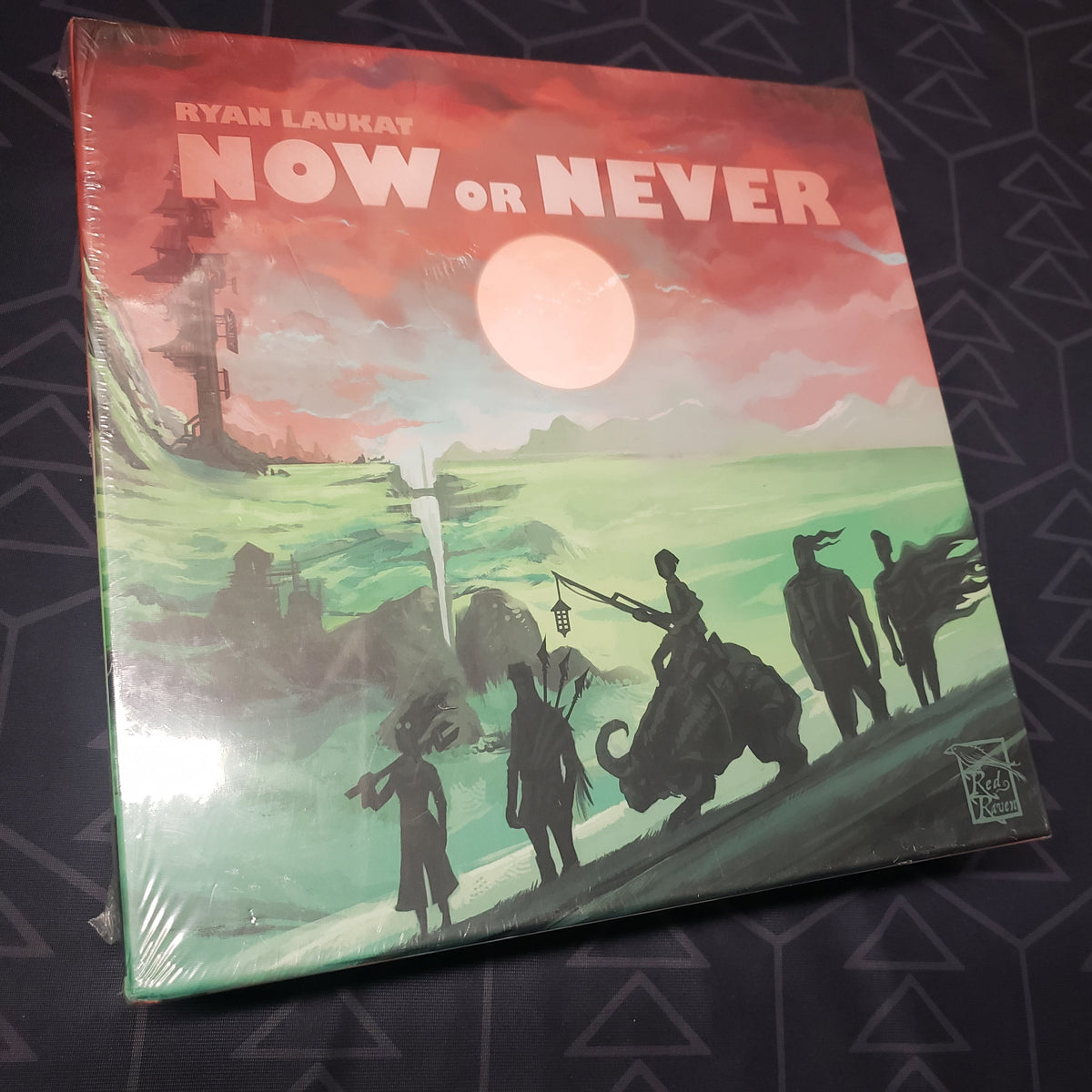 Image shows the front cover of the box of the Now or Never board game