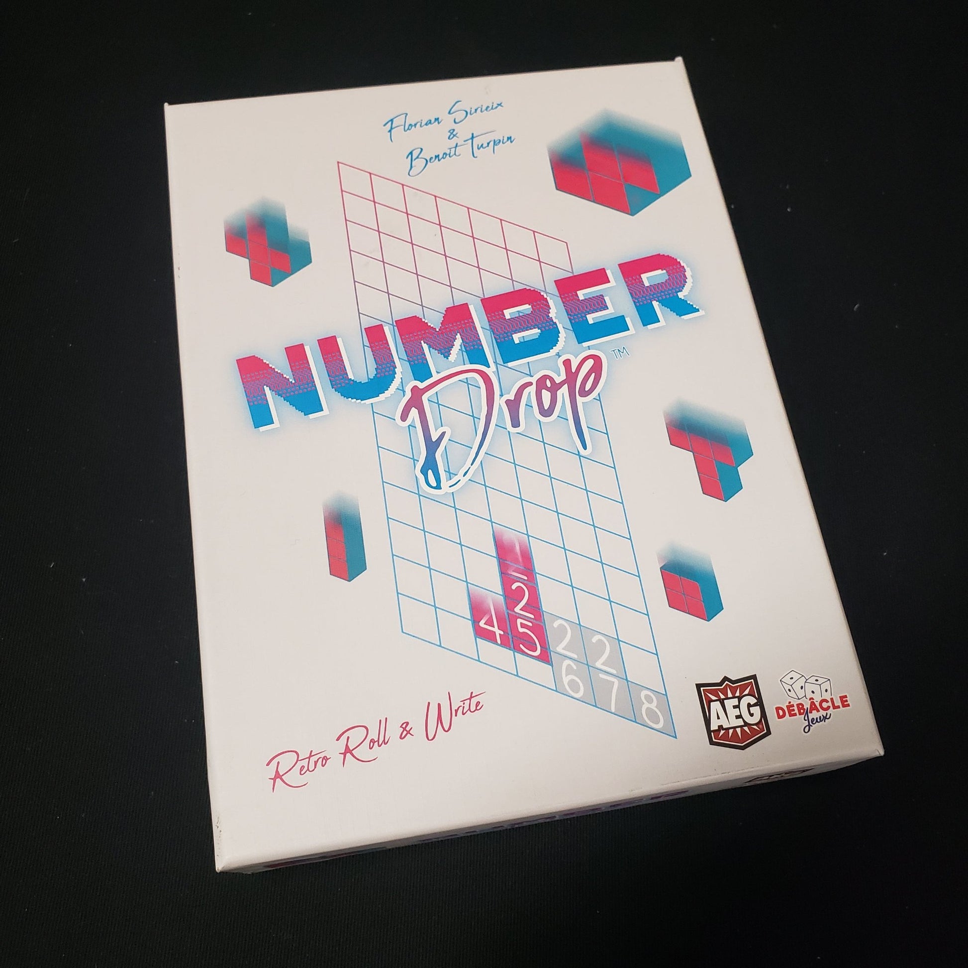 Image shows the front cover of the box of the Number Drop board game