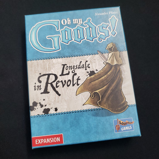 Image shows the front cover of the box of the Longsdale in Revolt expansion for the card game Oh My Goods!