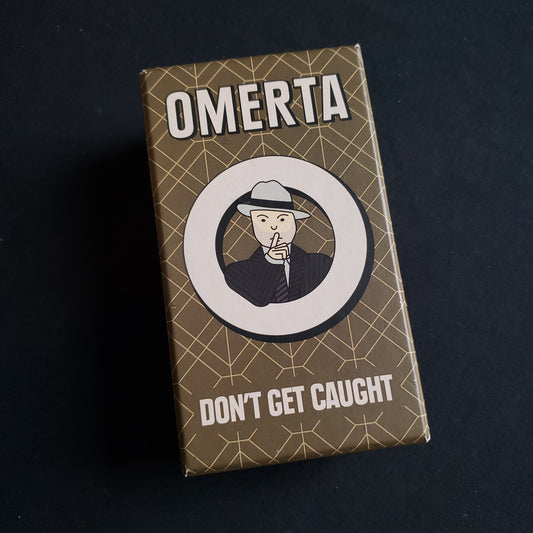 Image shows the front cover of the box of the Omerta card game