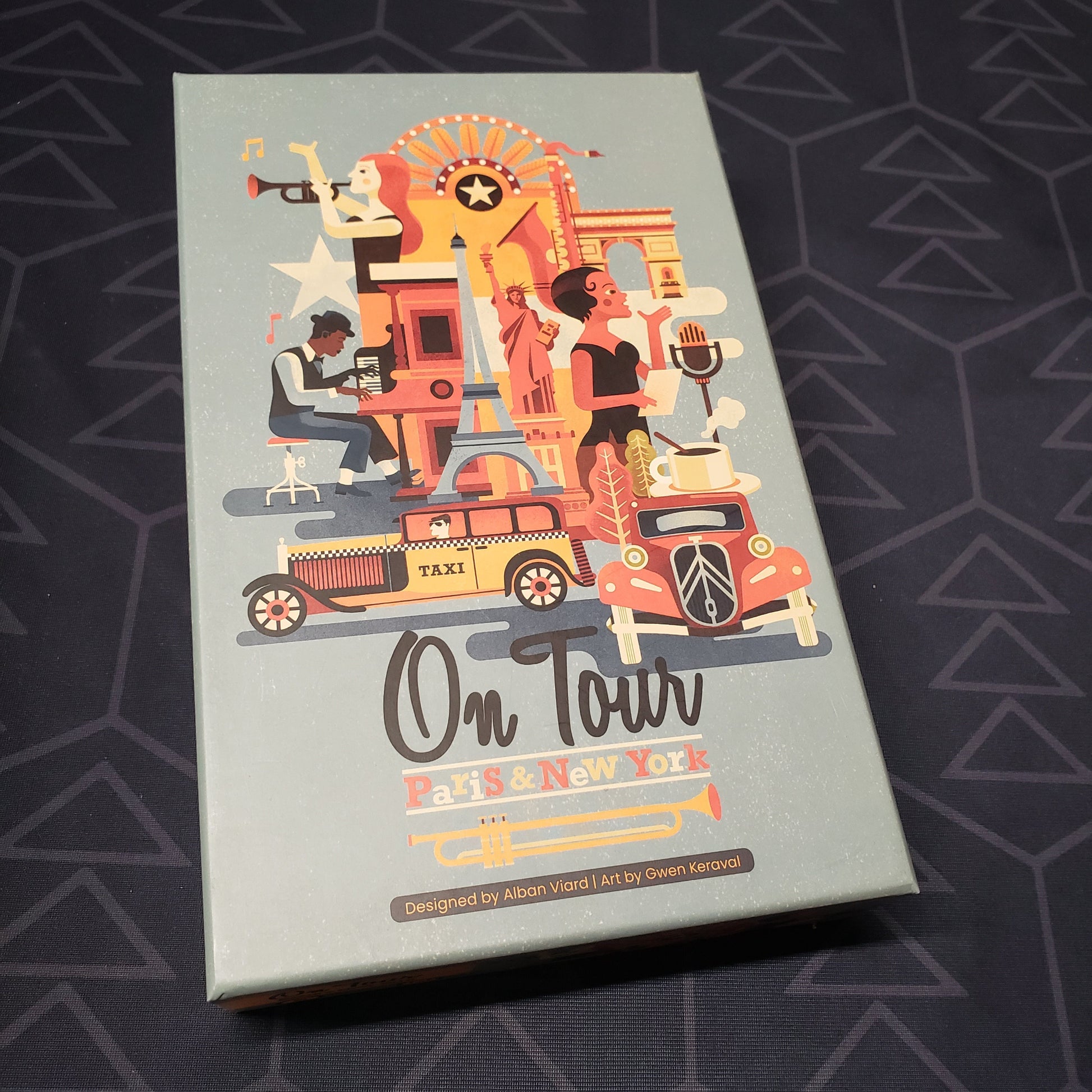 Image shows the front cover of the box for the On Tour: Paris & New York board game