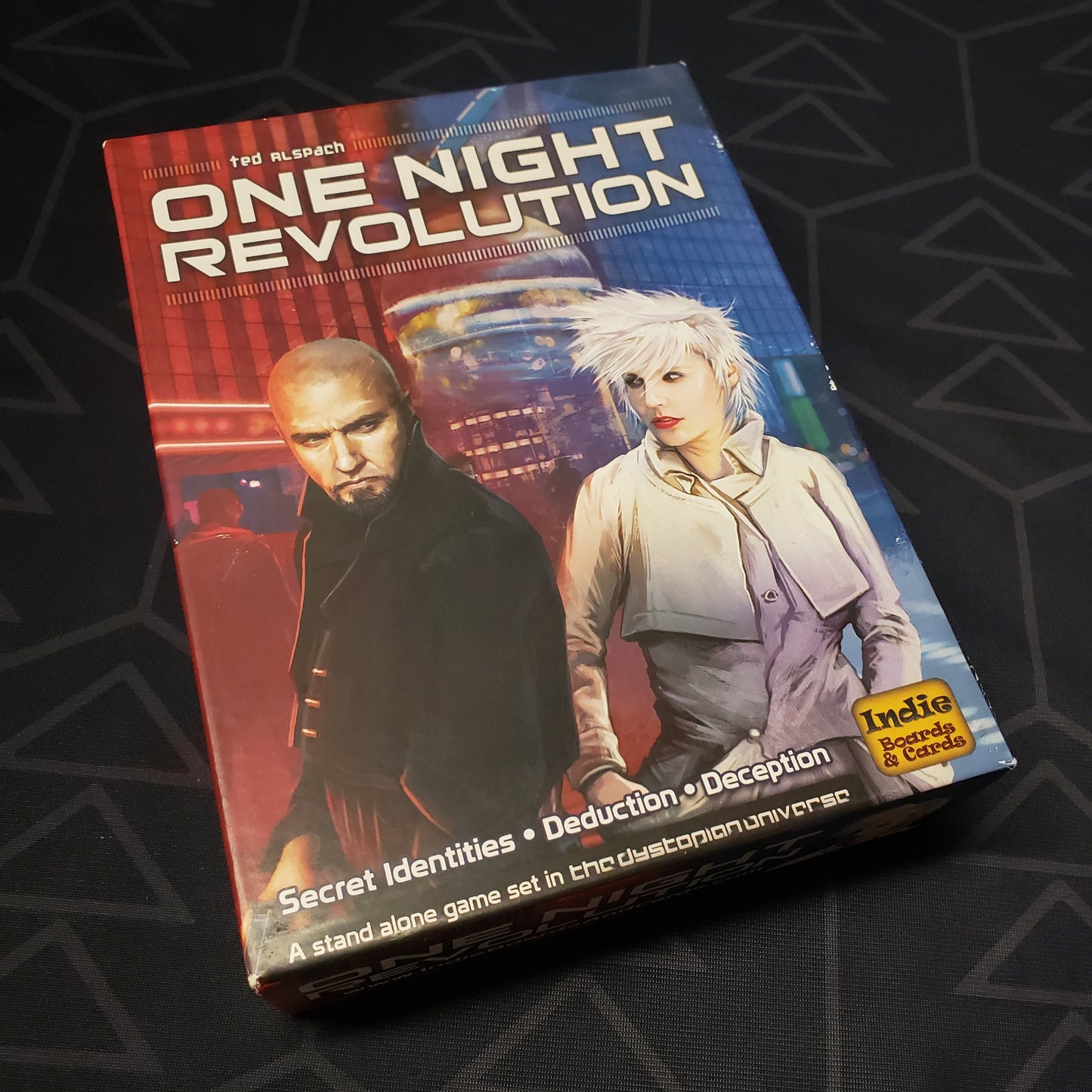 Image shows the front cover of the box of the One Night Revolution game