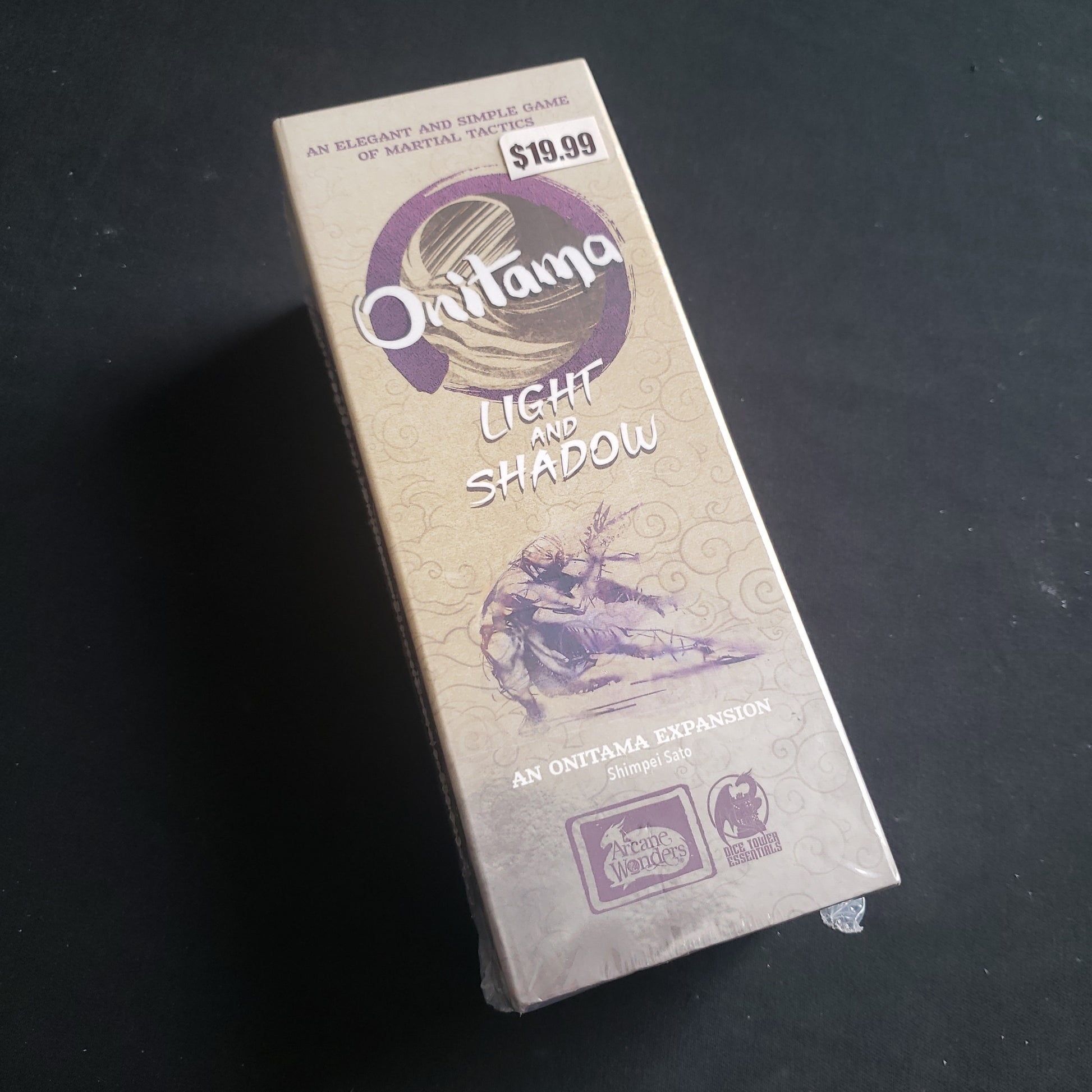 Image shows the front of the box for the Light & Shadow Expansion for the Onitama board game