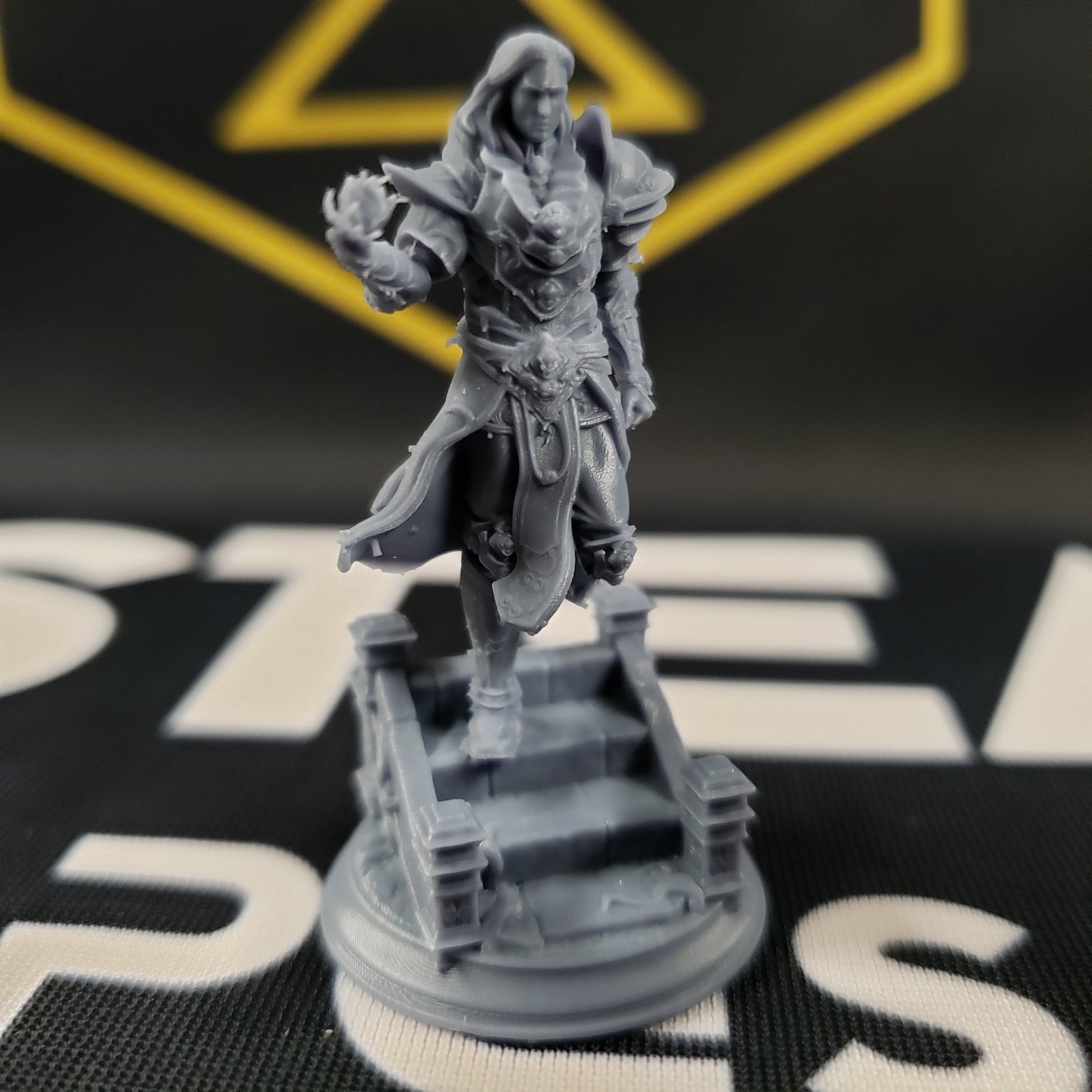 Image shows a 3D printed human wizard gaming miniature, walking down some steps and conjuring a spell with one hand