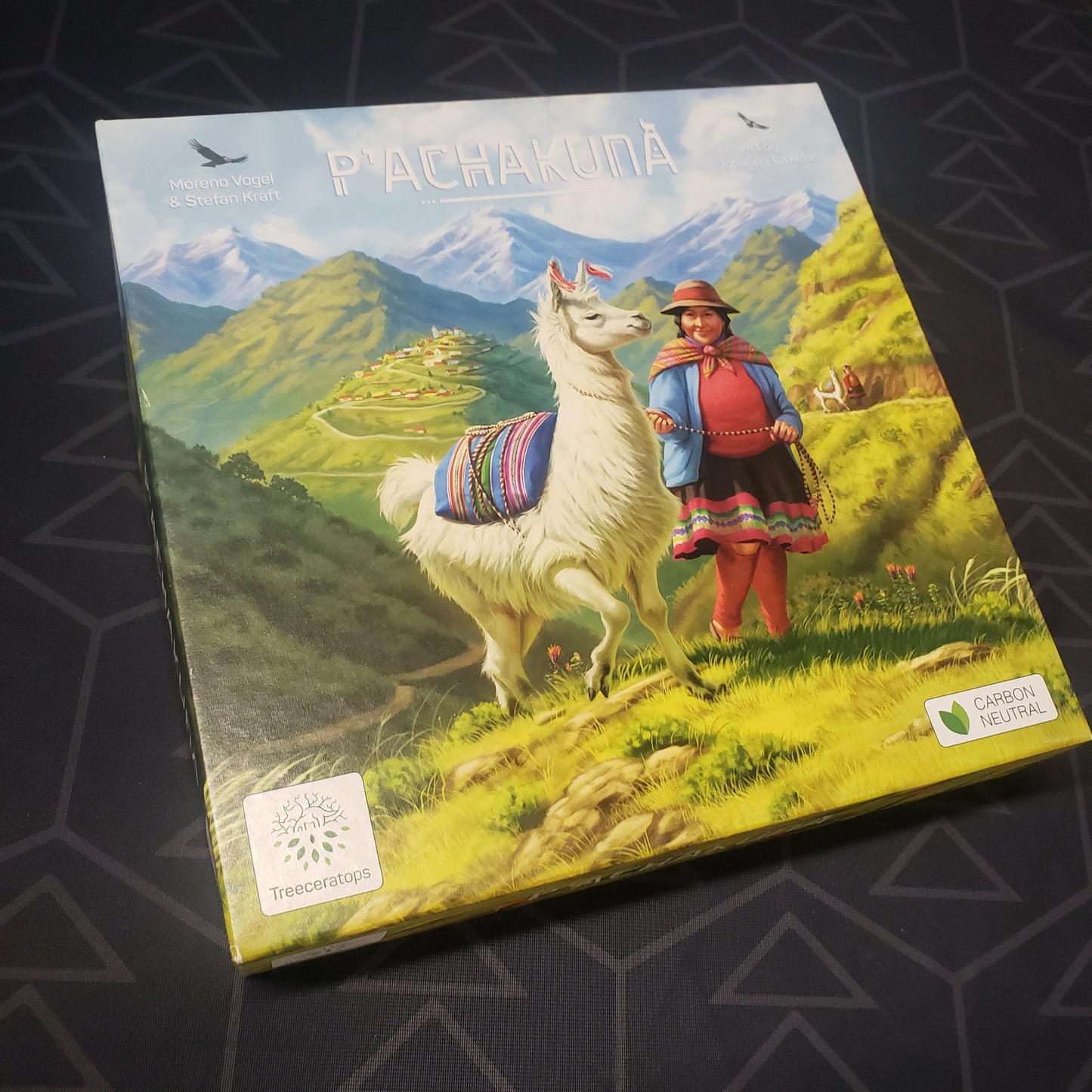Image shows the front cover of the box for the P'achakuna board game