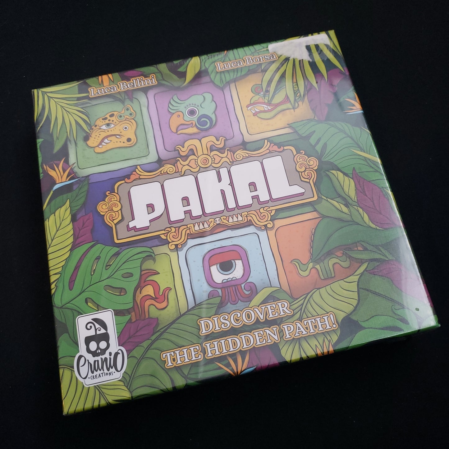 Image shows the front cover of the box of the Pakal board game