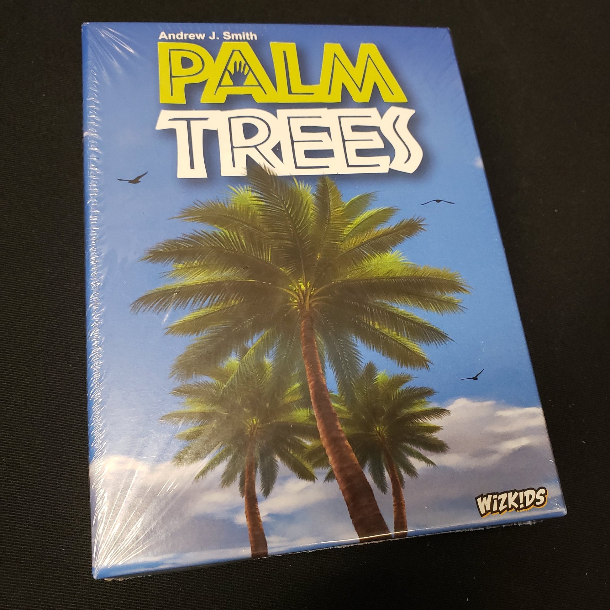 Image shows the front cover of the box of the Palm Trees card game