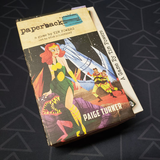 Image shows the front cover of the box for the Paperback card game