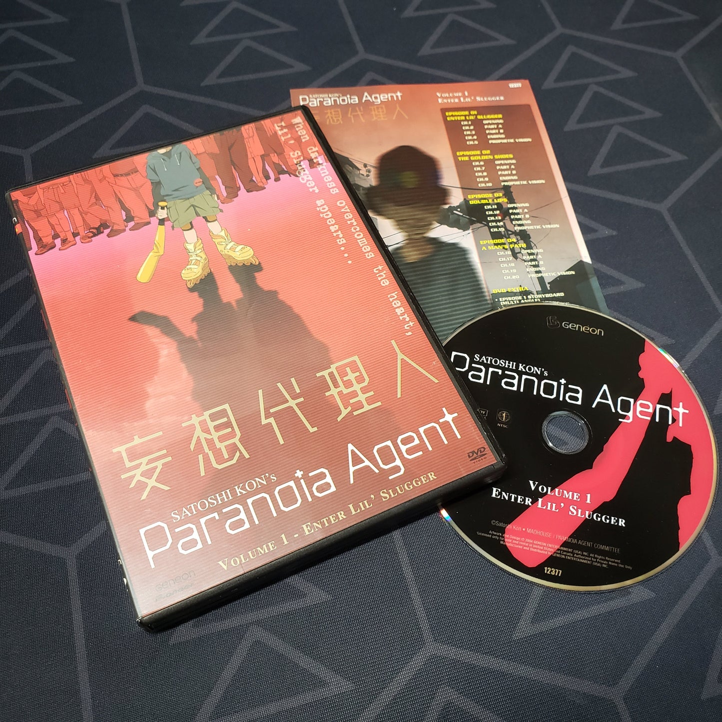 Image shows the case, insert & disc for the Volume 1: Enter Lil' Slugger episode disc of the anime TV series Paranoia Agent on DVD