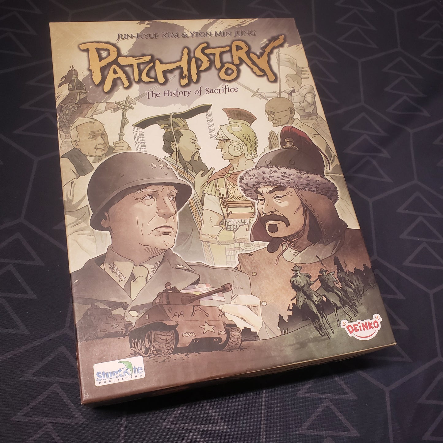 Image shows the front cover of the box of the Patchistory board game