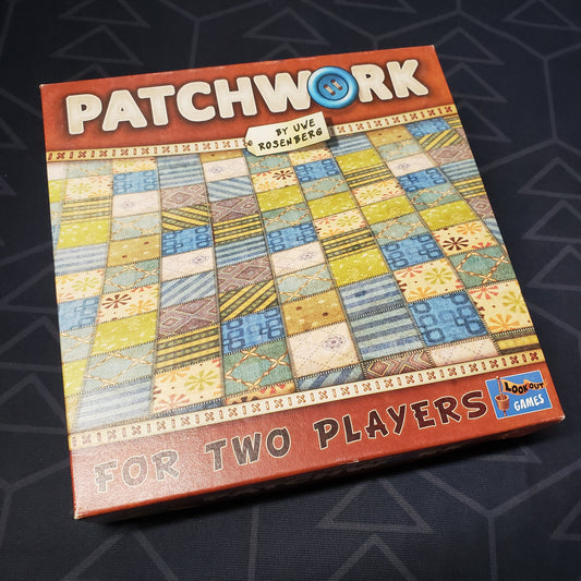 Image shows the front cover of the box of the Patchwork board game
