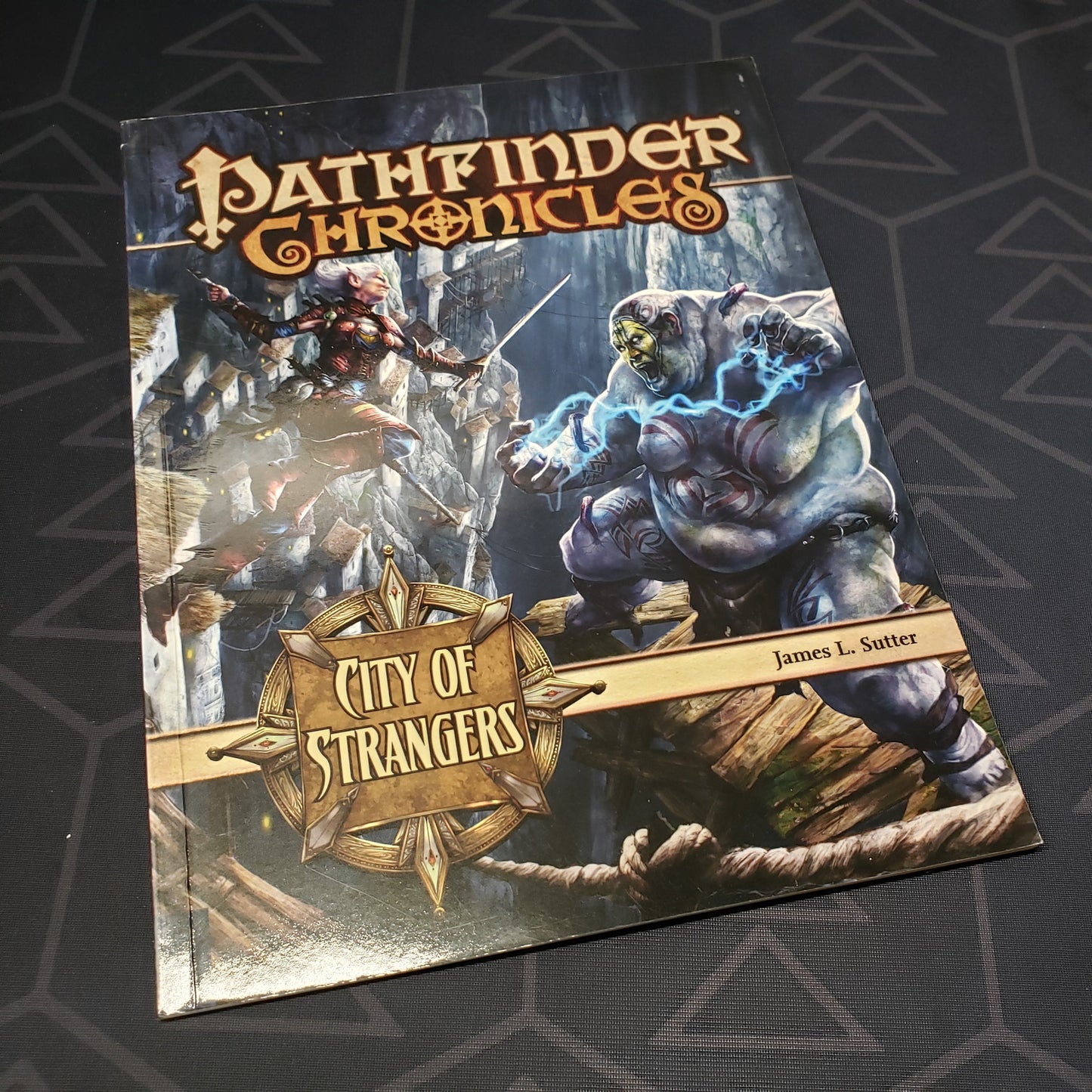 Image shows the front cover of the Chronicles: City of Strangers book for the roleplaying game Pathfinder 1E