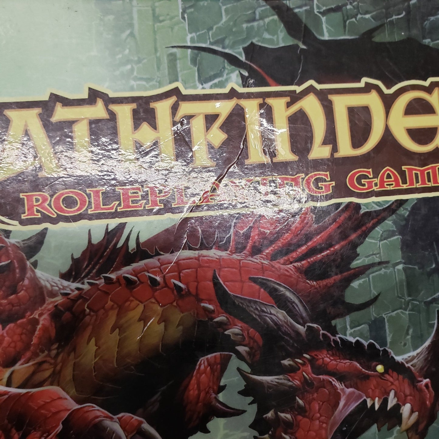 Image shows a close-up of a crease on the cover of the core rulebook for Pathfinder 1E