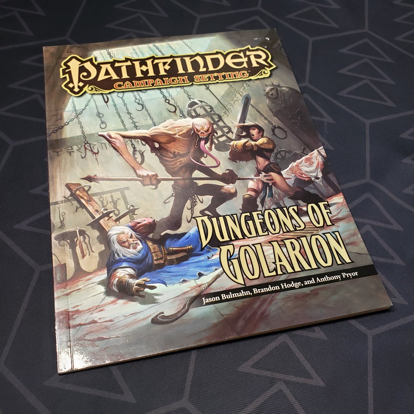 Image shows the front cover of the Dungeons of Golarion book for the roleplaying game Pathfinder 1E