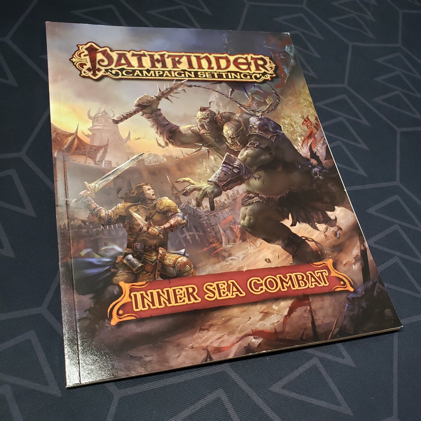 Image shows the front cover of the Inner Sea Combat book for the roleplaying game Pathfinder 1E