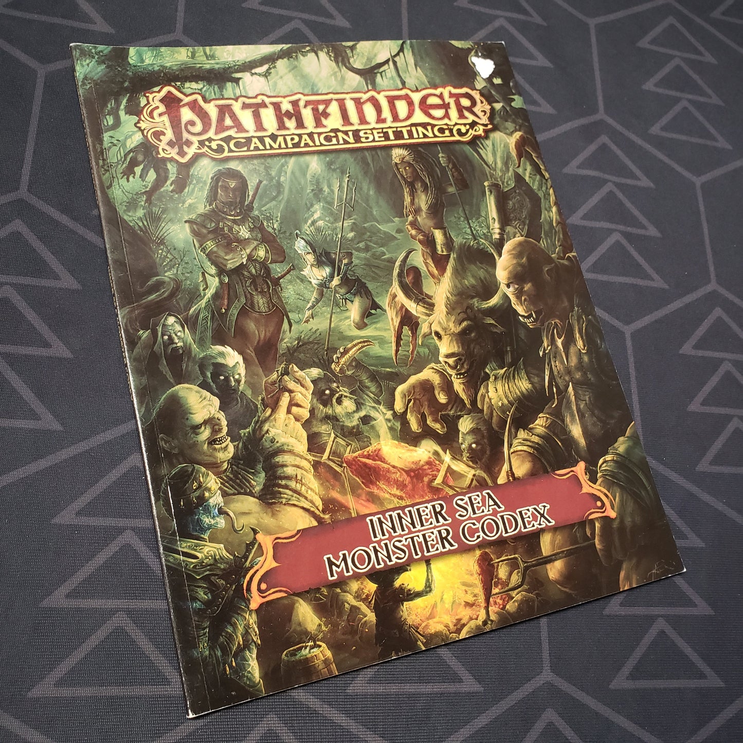 Image shows the front cover of the Inner Sea Monster Codex book for the roleplaying game Pathfinder 1E