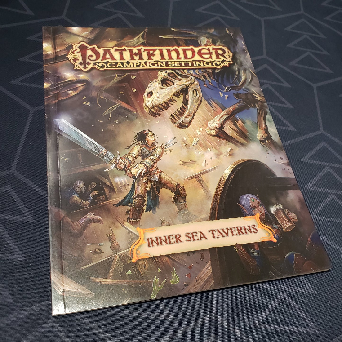 Image shows the front cover of the Inner Sea Taverns book for the roleplaying game Pathfinder 1E