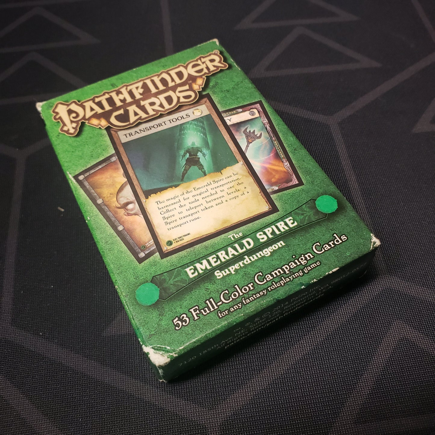 Image shows the front cover of the box for the Emerald Spire Superdungeon card deck for the roleplaying game Pathfinder 1E