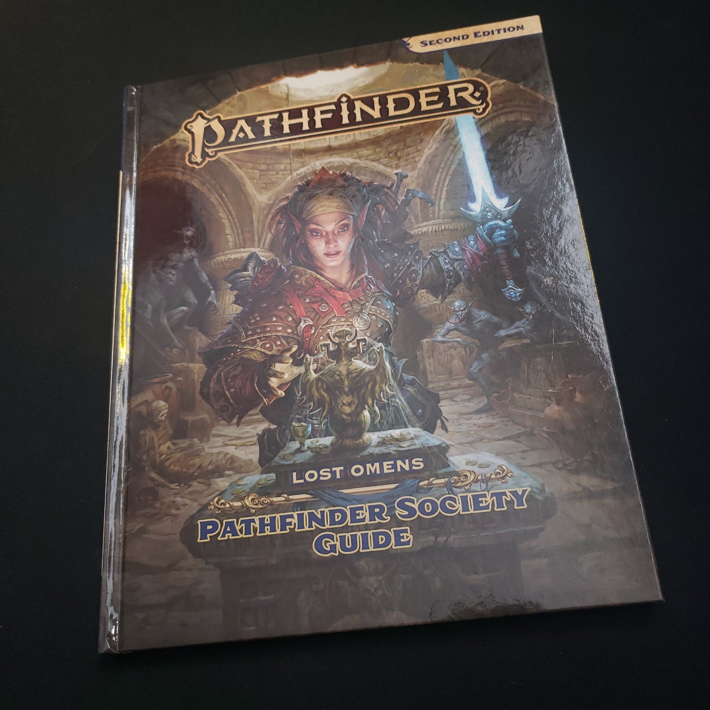 Image shows the front cover of the Lost Omens: Pathfinder Society Guide book for the Pathfinder 2E roleplaying game
