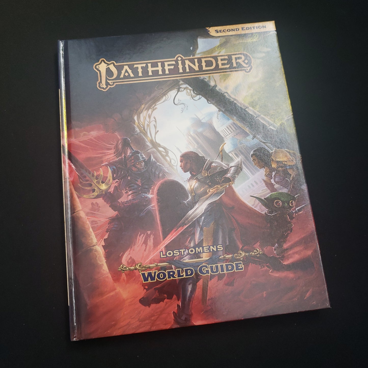Image shows the front cover of the Lost Omens: World Guide book for the Pathfinder 2E roleplaying game