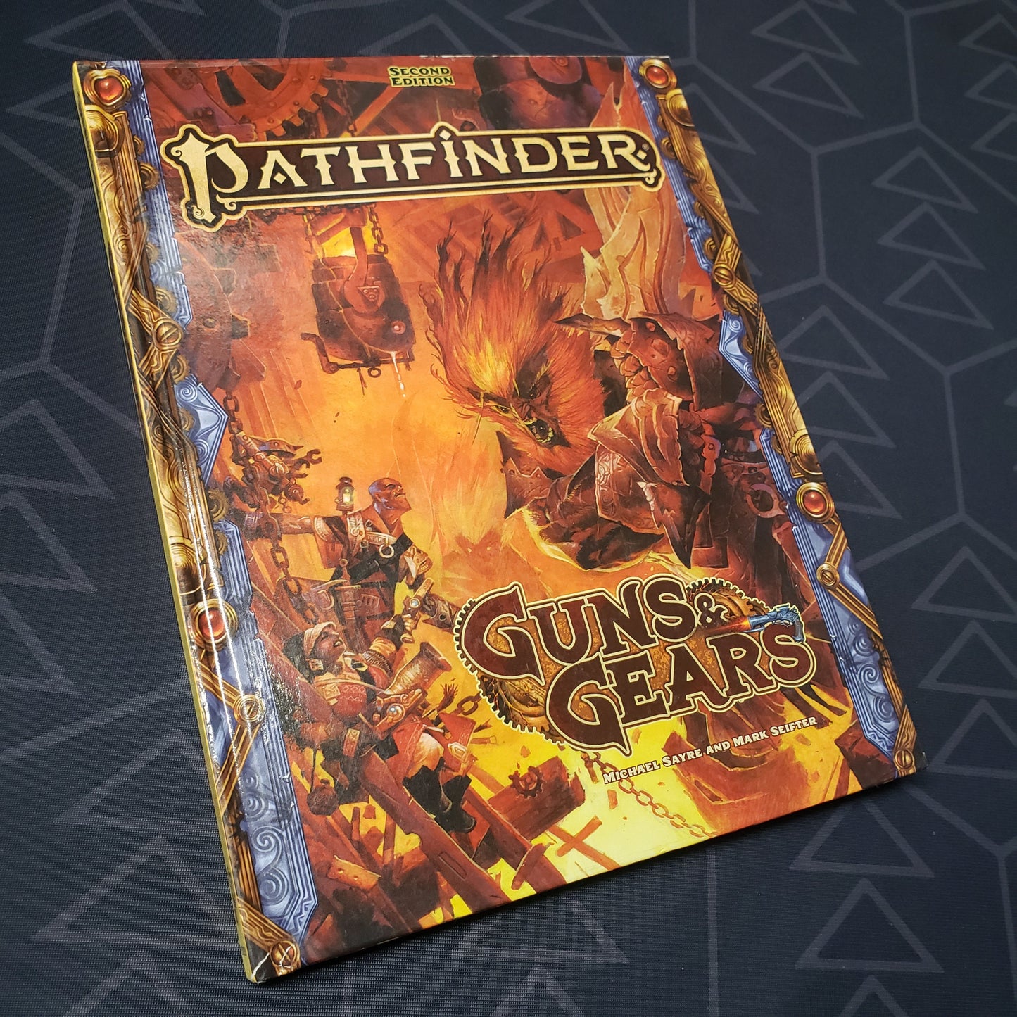 Image shows the front cover of the Guns & Gears book for the roleplaying game Pathfinder 2E