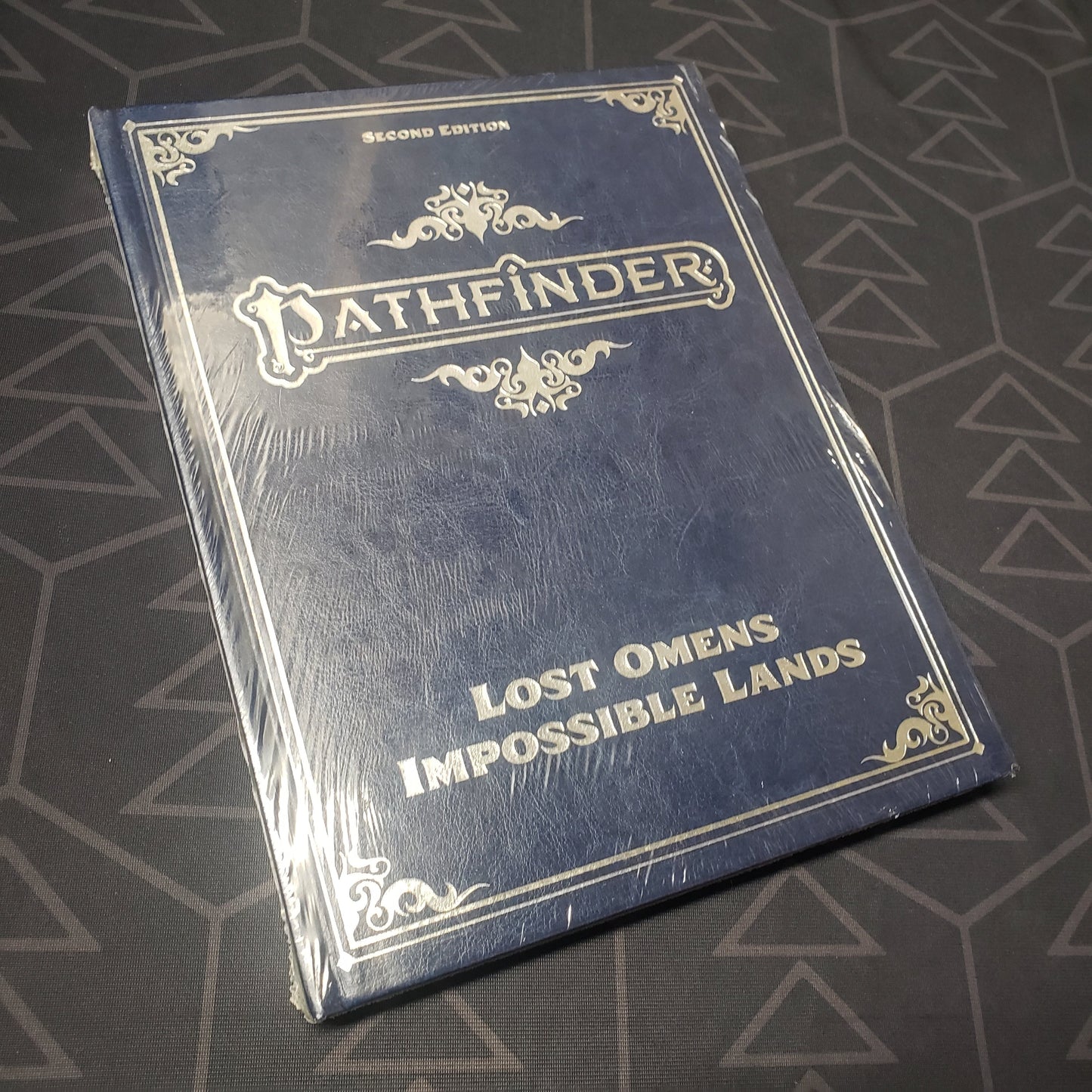 Image shows the front cover of the Lost Omens: Impossible Lands (Special Edition) book for the roleplaying game Pathfinder 2E